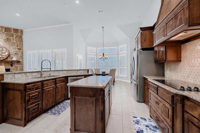 4994 Dogwood Dr, Celina, TX 75009 - kitchen featuring appliances with stainless steel finishes, a kitchen island with sink, premium range hood, backsplash, and a chandelier