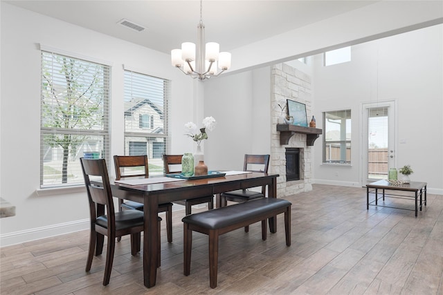 564 Embargo Dr, Fate, TX 75189 - dining room with an inviting chandelier, light wood finished floors, visible vents, and baseboards