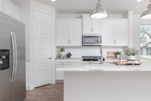 564 Embargo Dr, Fate, TX 75189 - kitchen featuring white cabinets, dark wood-style floors, stainless steel appliances, backsplash, and hanging light fixtures