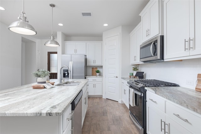 564 Embargo Dr, Fate, TX 75189 - kitchen with a sink, recessed lighting, wood finished floors, an island with sink, and appliances with stainless steel finishes