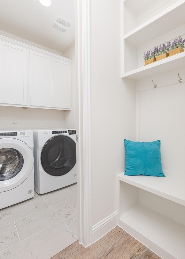 564 Embargo Dr, Fate, TX 75189 - washroom featuring separate washer and dryer, cabinet space, light wood finished floors, baseboards, and visible vents