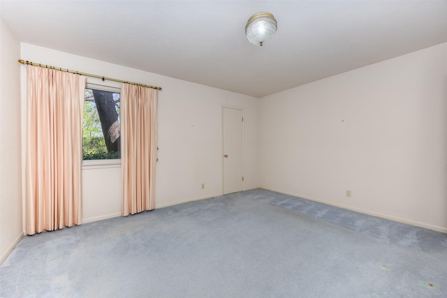 carpeted empty room with baseboards