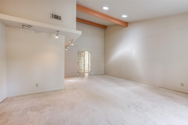 unfurnished room with visible vents, beam ceiling, carpet floors, baseboards, and recessed lighting