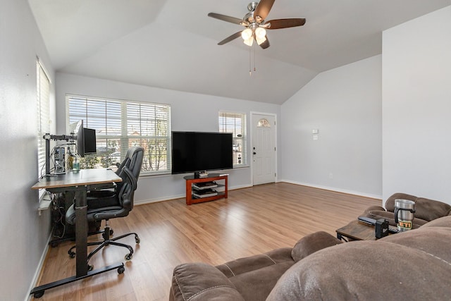 home office featuring baseboards, wood finished floors, a ceiling fan, and vaulted ceiling