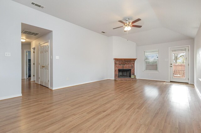 unfurnished living room featuring visible vents, ceiling fan, a brick fireplace, and vaulted ceiling