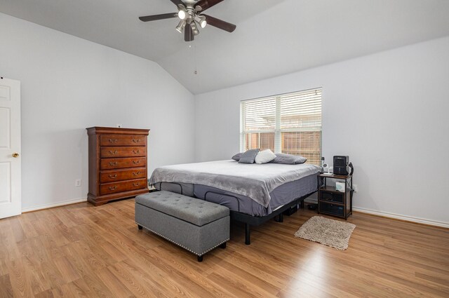bedroom featuring ceiling fan, baseboards, lofted ceiling, and light wood-style floors