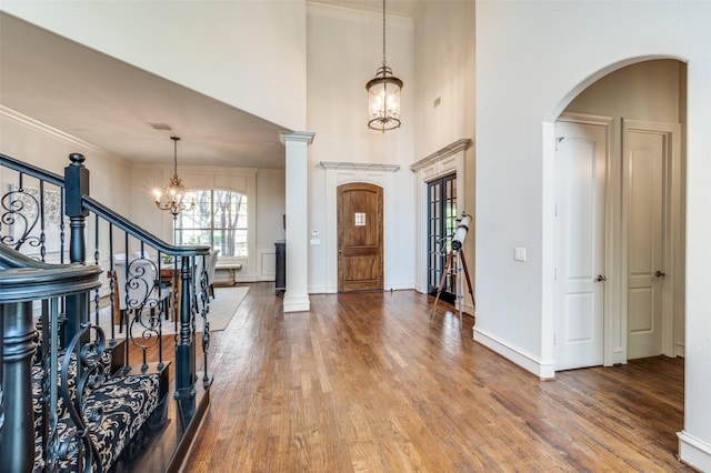 7201 Millard Pond Dr, Mckinney, TX 75071 - foyer entrance with a chandelier, arched walkways, wood finished floors, stairway, and ornamental molding