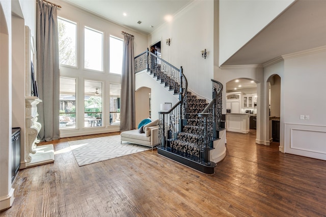7201 Millard Pond Dr, Mckinney, TX 75071 - foyer entrance with arched walkways, crown molding, a towering ceiling, stairway, and wood finished floors
