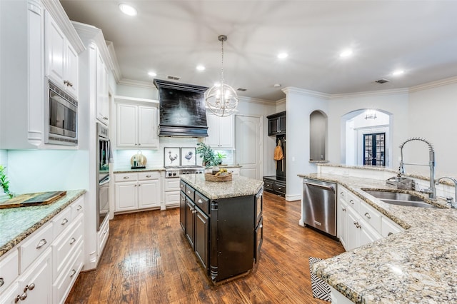 7201 Millard Pond Dr, Mckinney, TX 75071 - kitchen featuring a sink, stainless steel appliances, custom exhaust hood, arched walkways, and white cabinets