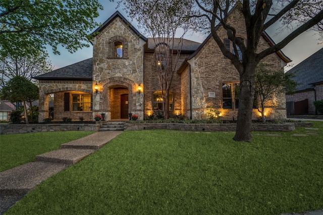 7201 Millard Pond Dr, Mckinney, TX 75071 - french country inspired facade featuring stone siding, a front yard, roof with shingles, and brick siding