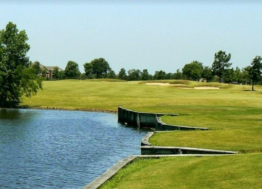 view of property's community featuring a lawn and a water view