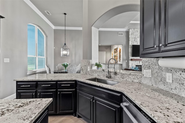 160 Pioneer Ct, Royse City, TX 75189 - kitchen with ornamental molding, a sink, dark cabinets, stainless steel dishwasher, and backsplash