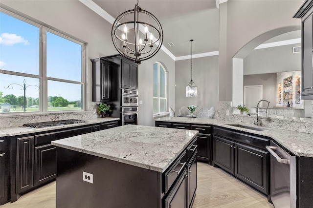 160 Pioneer Ct, Royse City, TX 75189 - kitchen with stainless steel appliances, a sink, ornamental molding, arched walkways, and a center island