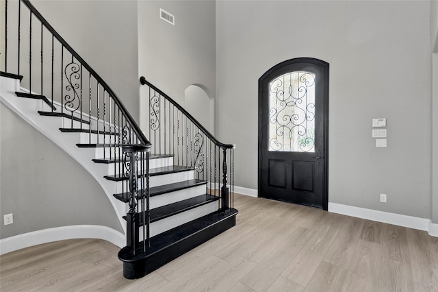 160 Pioneer Ct, Royse City, TX 75189 - foyer entrance featuring wood finished floors, baseboards, a towering ceiling, arched walkways, and stairs
