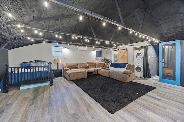 160 Pioneer Ct, Royse City, TX 75189 - cinema featuring stacked washer / dryer, wood finished floors, a barn door, and an AC wall unit