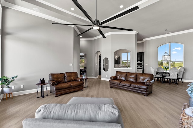 160 Pioneer Ct, Royse City, TX 75189 - living room featuring ornamental molding, baseboards, ceiling fan, arched walkways, and wood finished floors