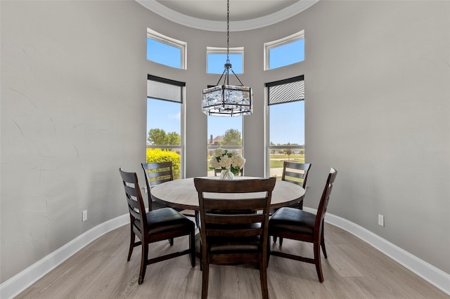 160 Pioneer Ct, Royse City, TX 75189 - dining space with a chandelier, plenty of natural light, light wood-type flooring, a high ceiling, and ornamental molding