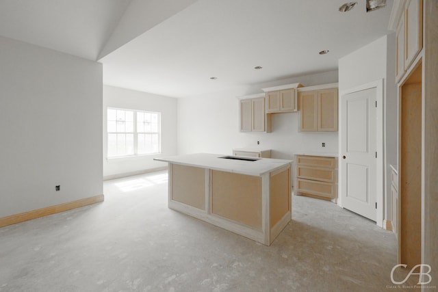3855 National Dr, Abilene, TX 79602 - kitchen featuring unfinished concrete floors, a kitchen island, light brown cabinets, and baseboards