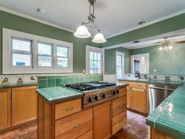 kitchen with tile countertops, stainless steel appliances, and a center island