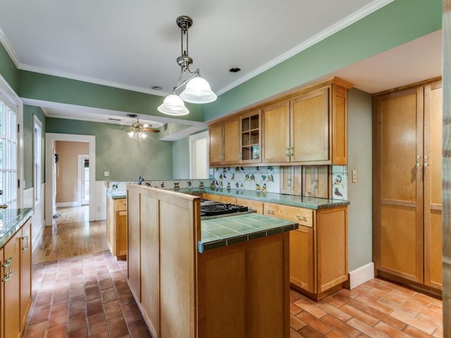 kitchen with tile countertops, tasteful backsplash, glass insert cabinets, and ornamental molding