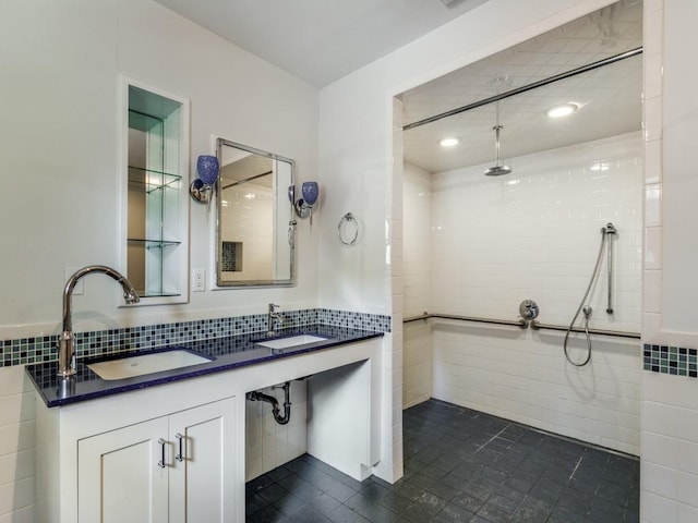 full bath featuring a sink, tile walls, and a walk in shower