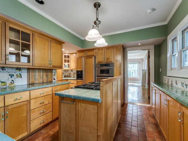 kitchen featuring backsplash, paneled built in fridge, stainless steel gas cooktop, and crown molding