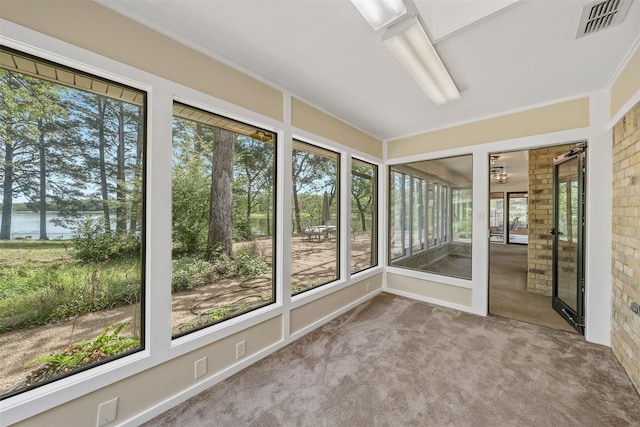 unfurnished sunroom featuring visible vents and a water view