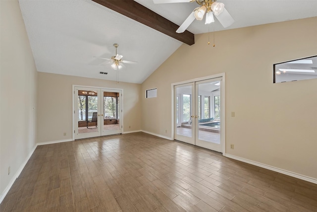 unfurnished living room featuring french doors, ceiling fan, vaulted ceiling with beams, and baseboards