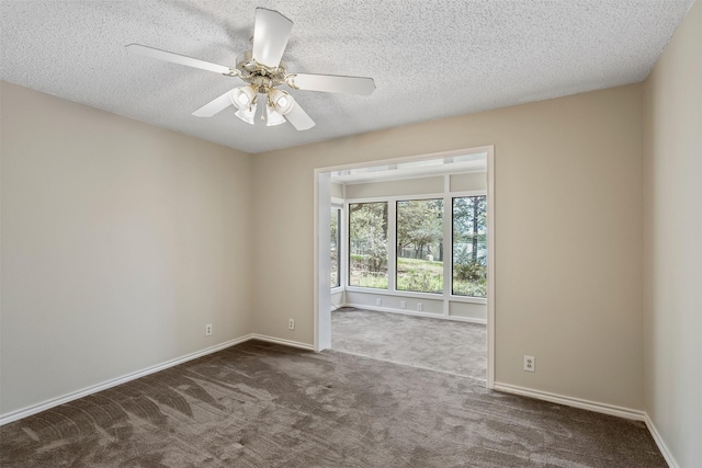 carpeted empty room featuring a textured ceiling, baseboards, and a ceiling fan