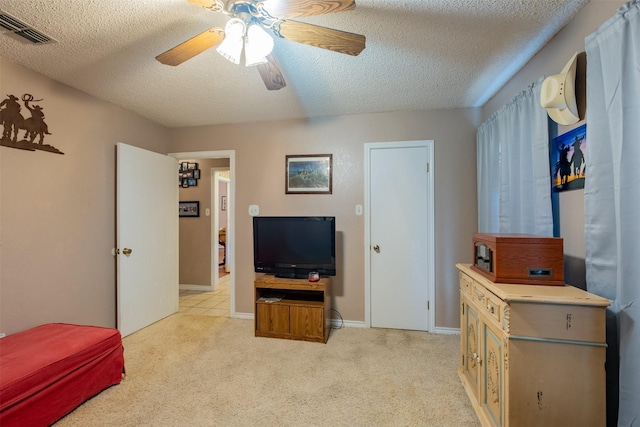 1511 Dolly Ln, Hideaway, TX 75771 - bedroom featuring a textured ceiling, light colored carpet, ceiling fan, and baseboards