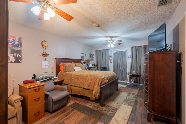 1511 Dolly Ln, Hideaway, TX 75771 - bedroom featuring a textured ceiling, wood finished floors, and ceiling fan