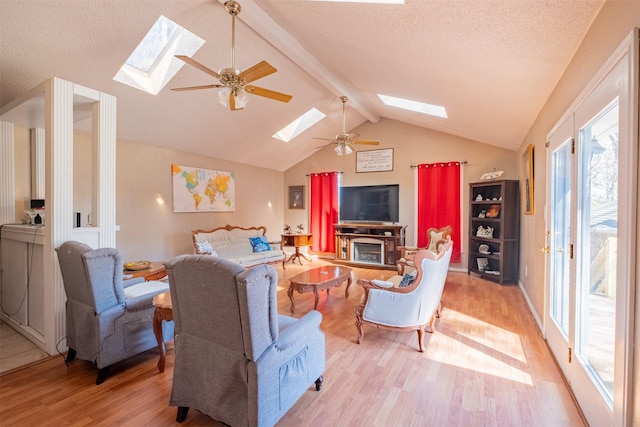 1511 Dolly Ln, Hideaway, TX 75771 - living room with a skylight, light wood finished floors, ceiling fan, and a textured ceiling