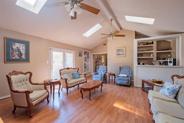 1511 Dolly Ln, Hideaway, TX 75771 - living room with a skylight, ceiling fan, light wood finished floors, a textured ceiling, and built in shelves