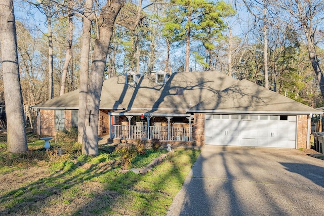 1511 Dolly Ln, Hideaway, TX 75771 - view of front of property with brick siding, a porch, a shingled roof, and driveway
