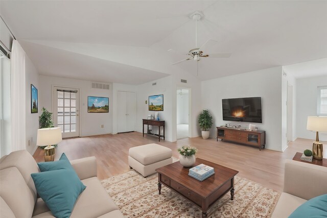 10550 High Hollows Dr Unit 233, Dallas, TX 75230 - living room featuring light wood-type flooring, healthy amount of natural light, vaulted ceiling, and a ceiling fan