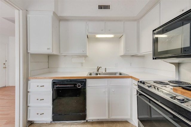10550 High Hollows Dr Unit 233, Dallas, TX 75230 - kitchen with black appliances, a sink, white cabinets, and light countertops