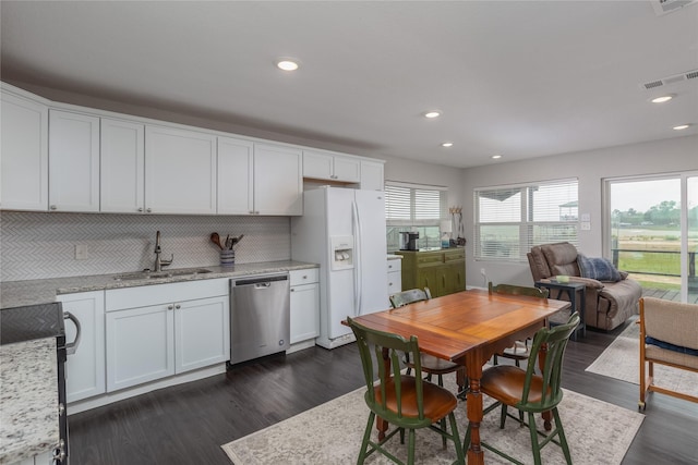 6827 Briar Rd, Azle, TX 76020 - kitchen featuring a sink, stainless steel dishwasher, white refrigerator with ice dispenser, tasteful backsplash, and dark wood-style floors