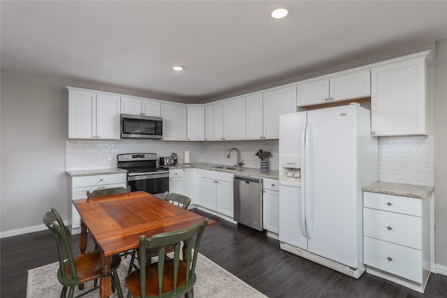6827 Briar Rd, Azle, TX 76020 - kitchen featuring appliances with stainless steel finishes, a sink, dark wood-type flooring, backsplash, and recessed lighting