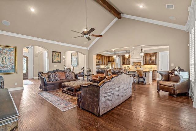 living room featuring visible vents, crown molding, ceiling fan, arched walkways, and dark wood-style floors