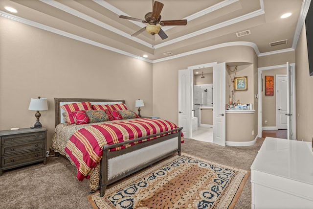 bedroom with ornamental molding, visible vents, carpet, and a raised ceiling