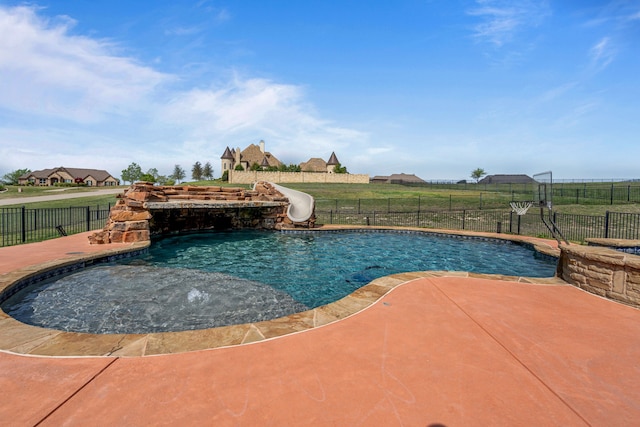 view of pool featuring a fenced in pool, a water slide, fence, and a patio area