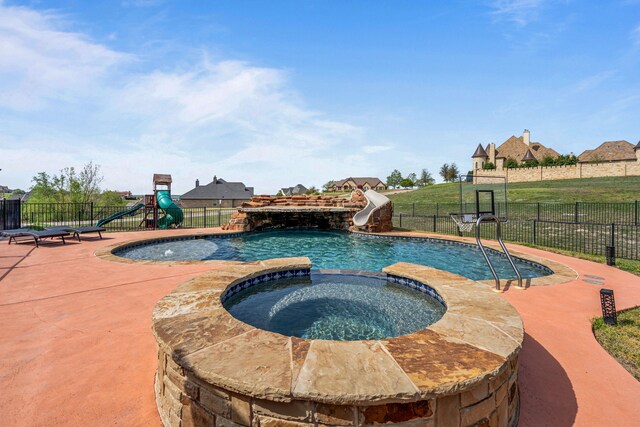 view of swimming pool with fence, playground community, a water slide, a patio, and a yard