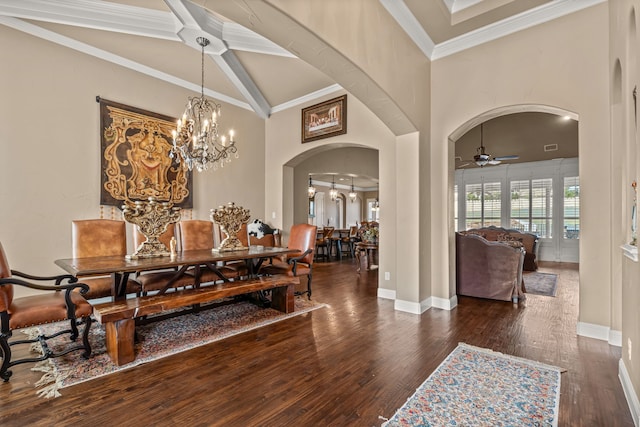 dining room featuring wood finished floors, baseboards, ceiling fan with notable chandelier, arched walkways, and ornamental molding