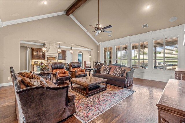 living area with wood finished floors, visible vents, arched walkways, and ceiling fan