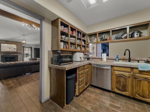 kitchen with black microwave, dishwasher, a sink, and open shelves