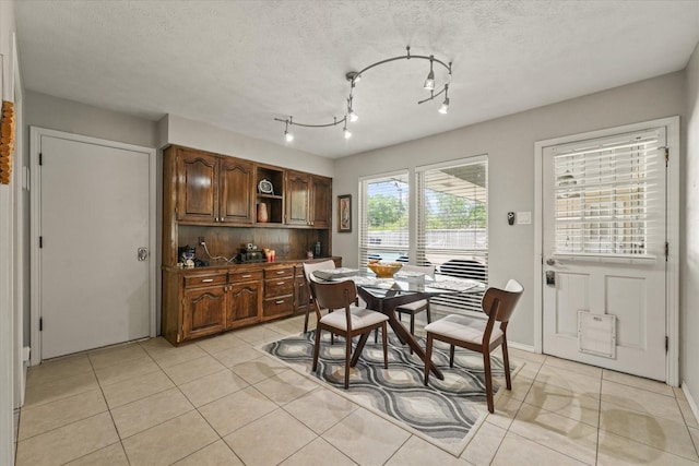 dining room with light tile patterned flooring and a textured ceiling
