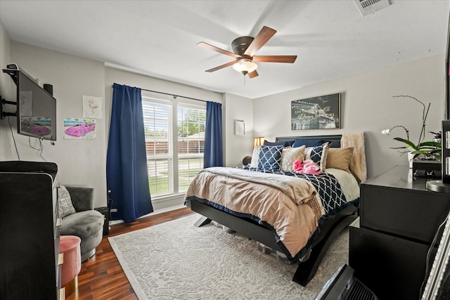 bedroom featuring dark wood-type flooring, ceiling fan, and visible vents