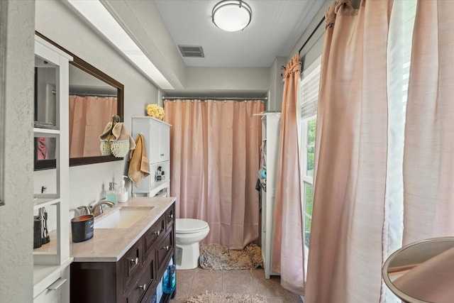 bathroom featuring toilet, tile patterned floors, vanity, and visible vents
