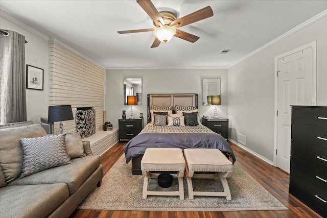 bedroom featuring a fireplace, visible vents, crown molding, and dark wood-style floors