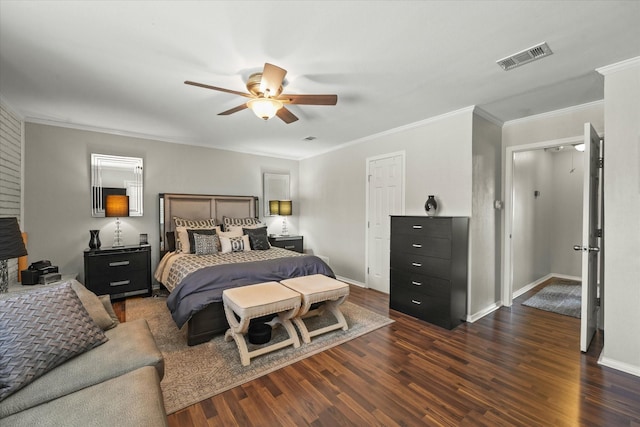 bedroom with ornamental molding, baseboards, dark wood finished floors, and visible vents